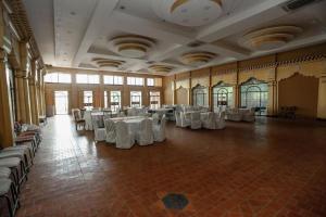 a large room with white tables and chairs in it at Grand Norling Hotel's Resort in Kathmandu
