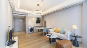 a living room with a couch and a table at Hefei Parkview Hotel in Hefei