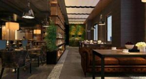a restaurant with a couch and tables and chairs at James Joyce Coffetel Beijing Yizhuang Rongjing East Street Subway Station in Beijing