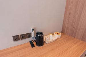 a coffee maker sitting on top of a wooden table at Royal Sweet By Sika in Canggu