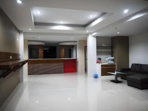 a large living room with a couch and a kitchen at Regent Room Hotel in Surat Thani