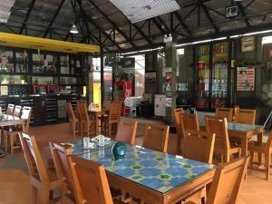 a dining room with a table and chairs at Tanisa Resort in Chumphon
