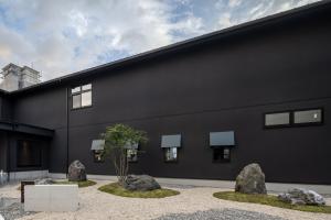 a black building with rocks in front of it at Hotel Yatsu in Komatsu
