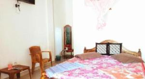 a bedroom with a bed and a table and a chair at Wenasa Hotel in Anuradhapura +21 photos