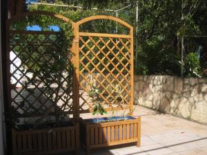 a wooden gate with a potted plant in it at Casa Bianca Rais Gerbi in Finale