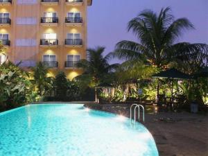 a hotel with a swimming pool in front of a building at Narita Classic Hotel in Tangerang