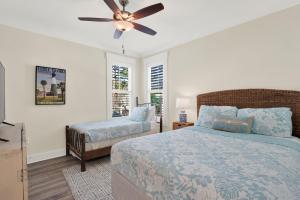 a bedroom with a bed and a ceiling fan at Blue Heaven Villa in Tybee Island +52 photos