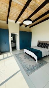 a bedroom with blue cabinets and a large bed at Duinen Suites in Walvis Bay