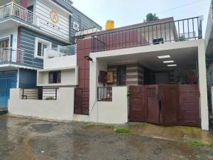 a house with a gate in front of it at SS Holiday Homes in Yenūr