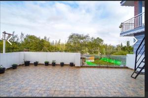 a backyard with a white fence and a basketball court at SS Holiday Homes in Yenūr