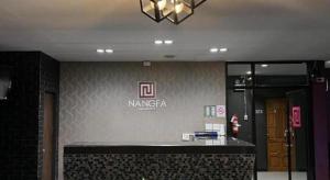 a lobby with a sign on the wall of a building at Nangfa Mini Hotel in Chiang Rai +92 photos