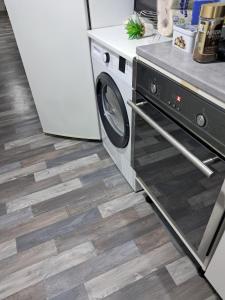 a kitchen with a washer and dryer on the floor at location dreux in Dreux