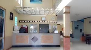 a large room with a counter in a building at Amarin Grand Hotel in Rayong