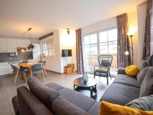 a living room with a couch and a table at Apartment near the ski slope in Brixen in Feuring