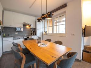 a kitchen with a wooden table and chairs at Apartment near the ski slope in Brixen in Feuring
