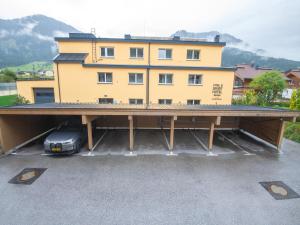 a car parked in a parking lot in front of a building at Modern apartment near the ski area in Brixen im Thale