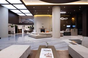 a lobby with couches and a fireplace in a building at Shanyujin Dellar Wild Luxury Hotel Luxury Mountain Retreat in Lijiang