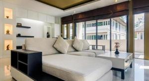 a living room with a couch and a table at Ocean Breeze Residence in Khao Lak +92 photos