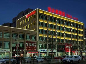 a building with a sign on top of it at ibis Tianjin Wuqing Hotel in Tianjin