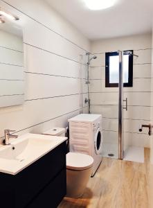 a bathroom with a toilet and a sink at Pinada La Mata in La Mata