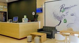 a waiting room with a cash register and a chair at 7 Days Premium·Xiamen Airport Xianglu in Xiamen