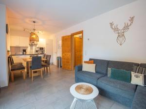 a living room with a blue couch and a table at Beautiful apartment with terrace in Feuring