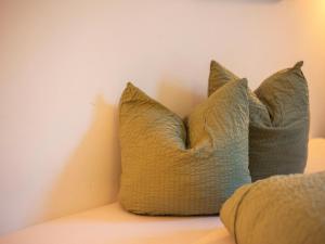 a pair of pillows sitting on top of a bed at Beautiful apartment with terrace in Feuring