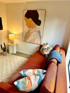 a couch in a living room with a painting on the wall at Heart of Mornington in Mornington