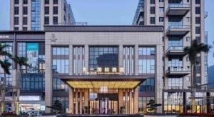 a large office building with a lit up facade at Taiyi International Hotel in Wenzhou