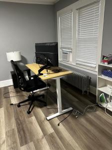 an office with a desk with a computer and a chair at Room Near Downtown Hartford in Hartford