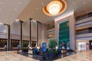 a lobby of a hotel with a large lobbyasteryasteryasteryasteryasteryasteryastery at New Century Grand Hotel Zhuji Yaojiang in Shaoxing +260 photos