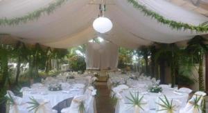 a banquet hall with white tables and white chairs at Le Manumea Hotel in Apia