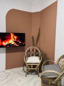 a living room with two chairs and a fireplace at Charming apartment heart of Medina Tetouan 2BR in Tetouan