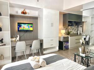Un dormitorio con una cama y un escritorio y una cocina. en The Cavana Suites, en Pusok