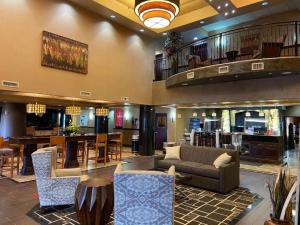 a lobby with a couch and a table and chairs at Best Western Plus KC Speedway Inn & Suites in Kansas City