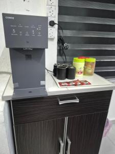 a coffee machine sitting on top of a counter at Syaf Homestay in Lunas +2 photos