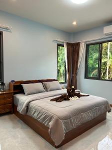 a bedroom with a large bed and two windows at Smile Home Krabi Klong Moung Beach in Klong Muang Beach +209 photos