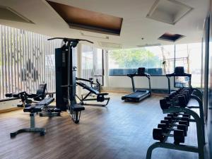 a gym with several treadmills and exercise bikes at Aristo 2 Condo with a sea view in Ban Lum Fuang