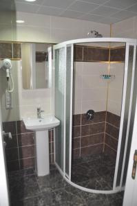 a bathroom with a shower, sink, and toilet at Grand Sera Hotel in Ankara