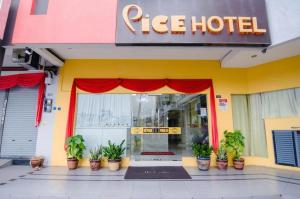 a tree hotel with potted plants in front of it at Pice Hotel in George Town