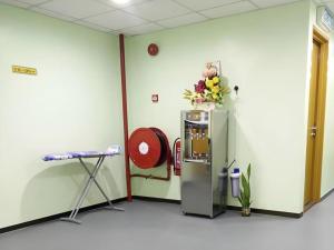 a room with a machine with flowers on top of it at ID Hotel Yayasan in Segamat