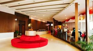 a lobby with a red circular seating in a building at Sri Manja Boutique Hotel in Kuantan