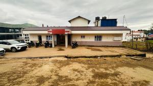 a house with motorcycles parked in front of it at VR Residency in Ooty