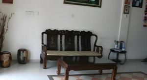 a bench sitting in the corner of a room at Rafayeh Hotel in Seremban
