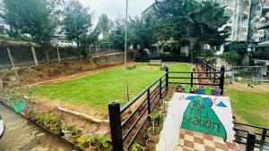 a table with a sign on it next to a park at VR Residency in Ooty +11 photos
