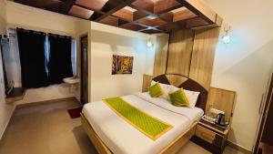 a bedroom with a large bed in a room at VR Residency in Ooty