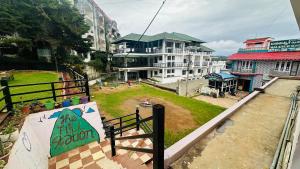 a view of a building from a balcony with a sign at VR Residency in Ooty