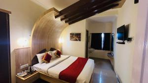 a bedroom with a large bed in a room at VR Residency in Ooty