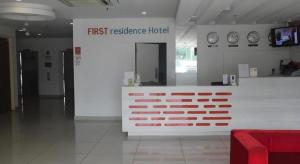 a first reference hotel with clocks on the wall at First Residence Hotel Kemaman in Cukai