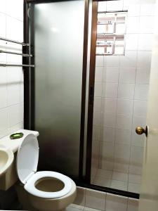 a bathroom with a toilet and a shower and a sink at 3 Bedroom House in the Heart of Baguio with Garage in Camp John Hay